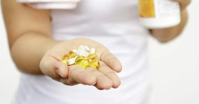 Woman Holding Hand full of Vitamins — MedSurg Weight Loss in Brisbane, QLD