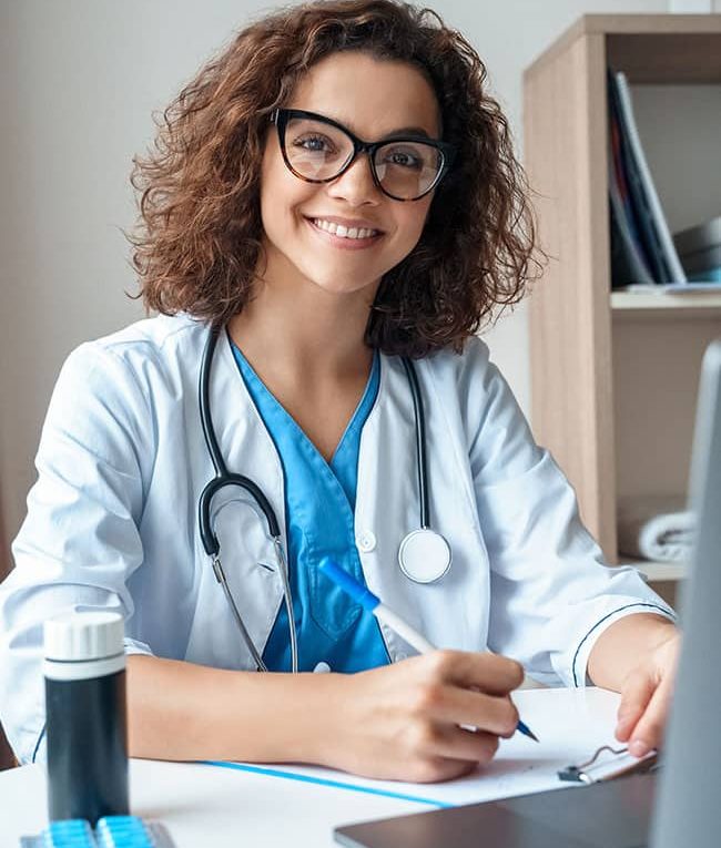 Doctor working on desk with laptop — MedSurg Weight Loss in Brisbane, QLD