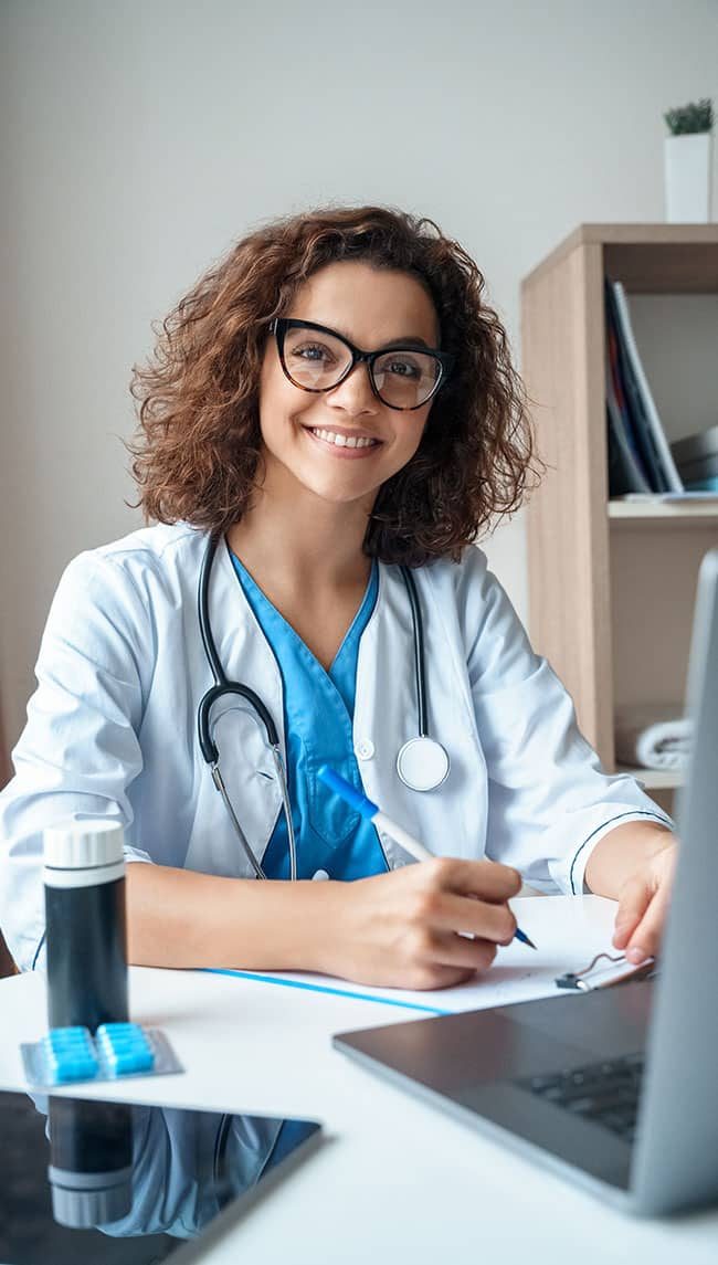 Doctor working on desk with laptop — MedSurg Weight Loss in Brisbane, QLD